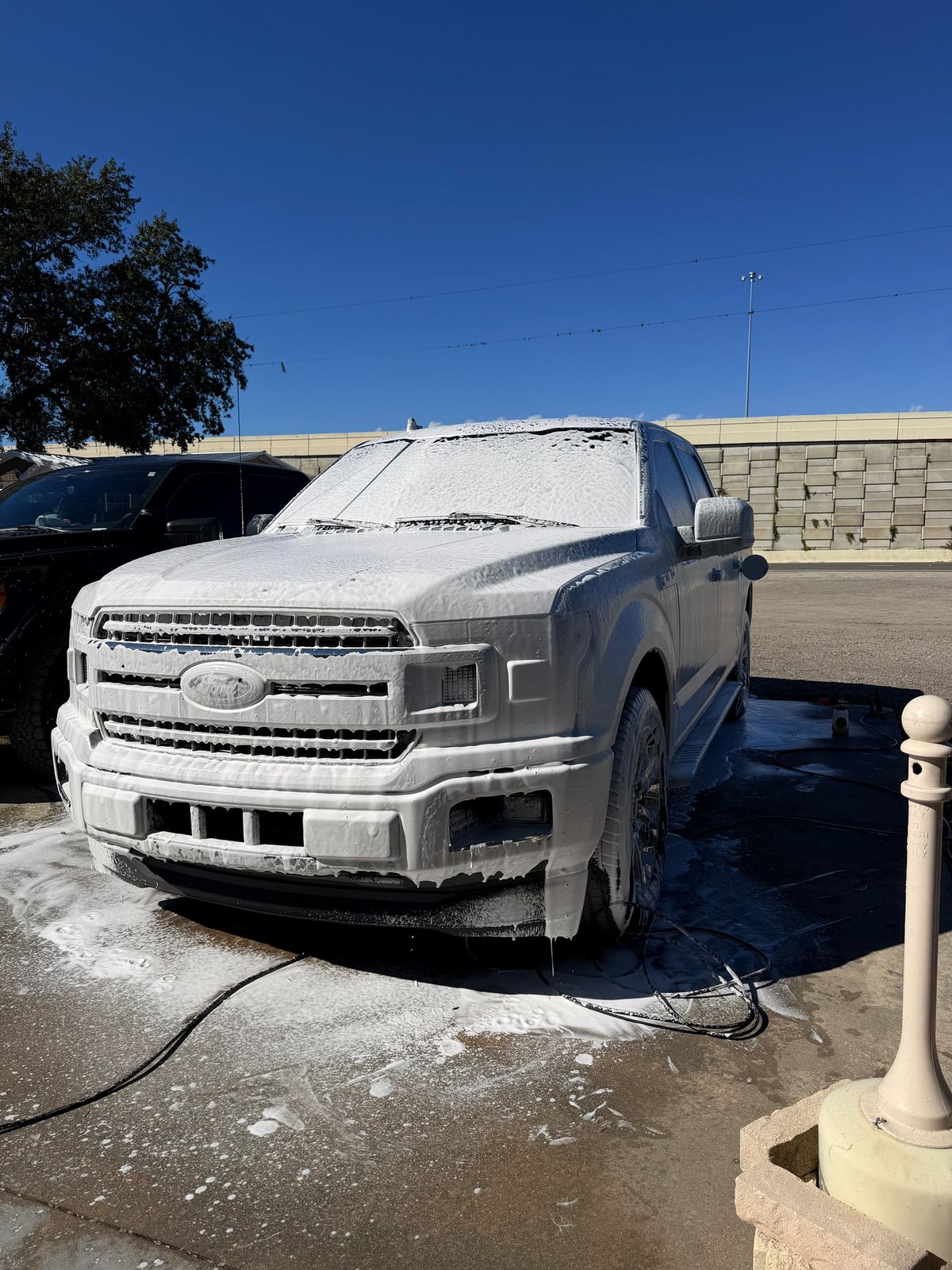 Pickup truck covered in foam during an exterior hand wash